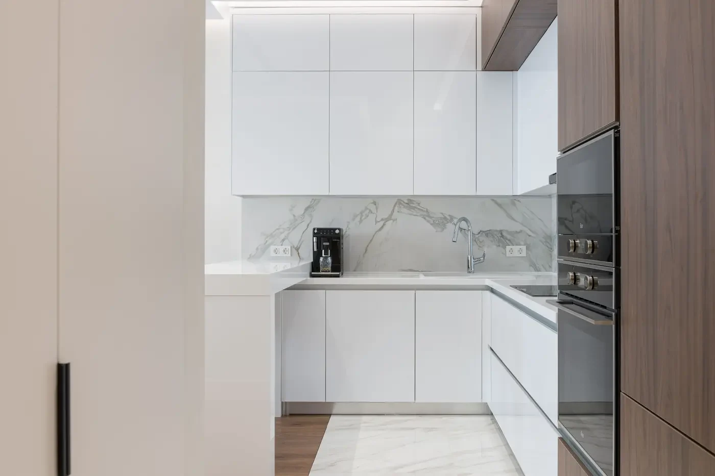 Representative kitchen with built-in ovens and appliances coordinated within finished cabinetry