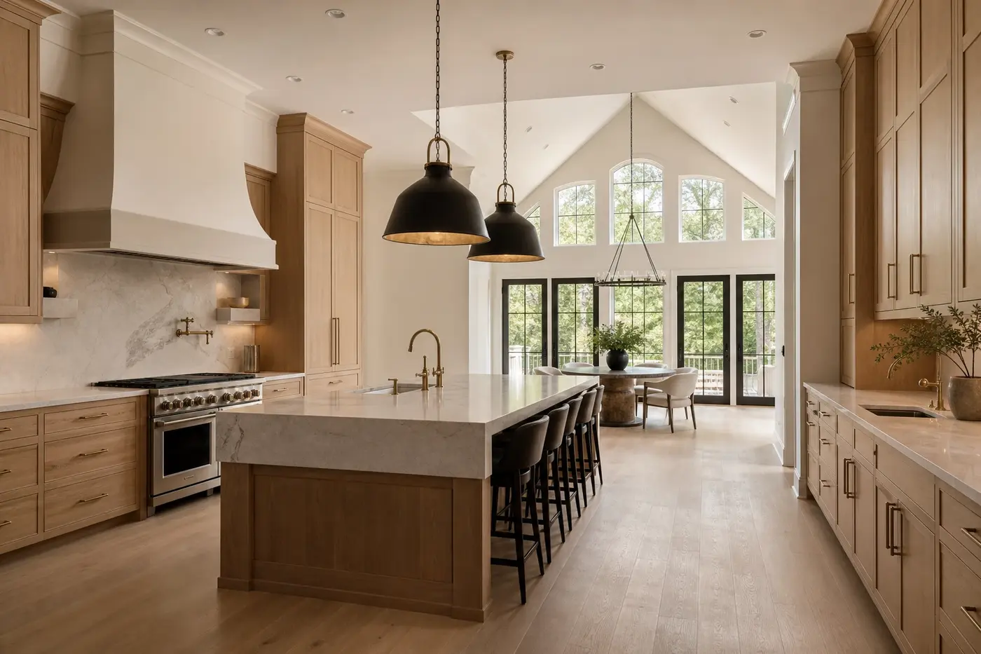 New custom-home kitchen with coordinated cabinetry, pendant lights, flat ceiling, and vaulted breakfast room