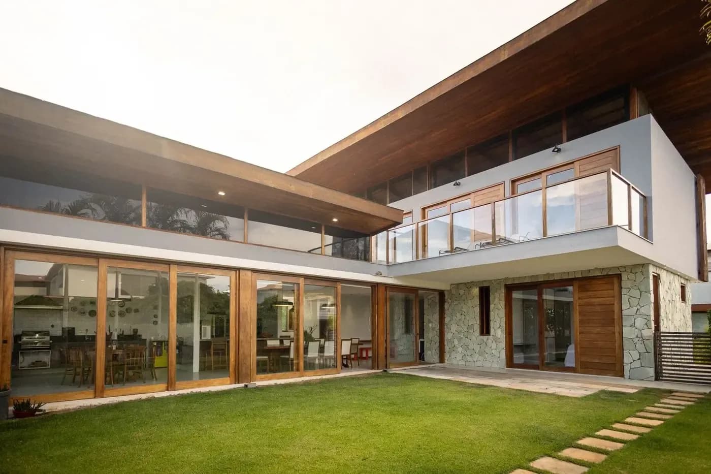 Representative luxury custom home with coordinated wood, stone, glass, and roof details