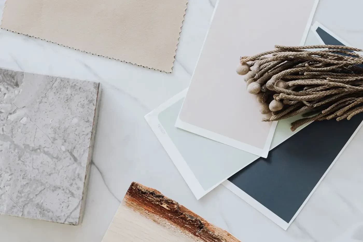 Representative neutral stone, wood, textile, and finish samples for a custom home