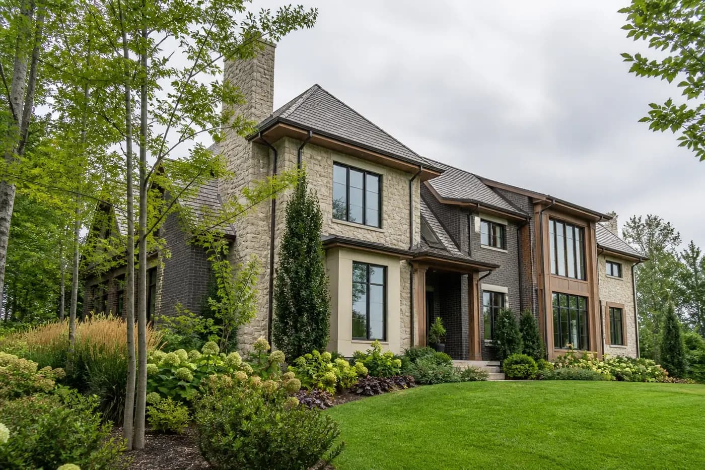 New Charlotte luxury custom home with coordinated rooflines, deep eaves, masonry walls, windows, gutters, and landscaped grade