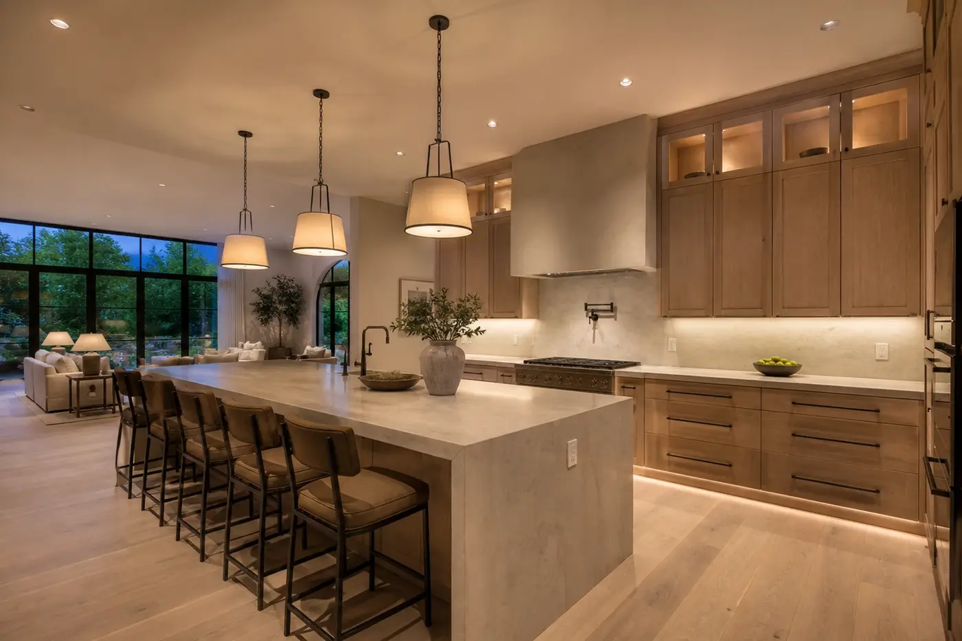 Luxury Charlotte custom-home kitchen with coordinated pendants, recessed lighting, appliance connections, and discreet island power