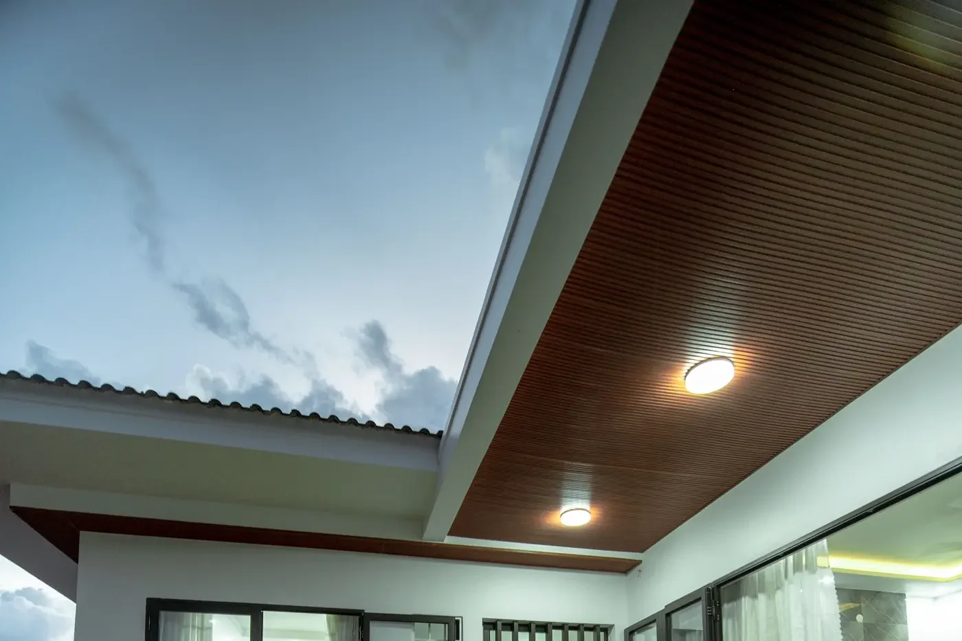 Representative covered entry showing recessed exterior fixtures integrated into a soffit