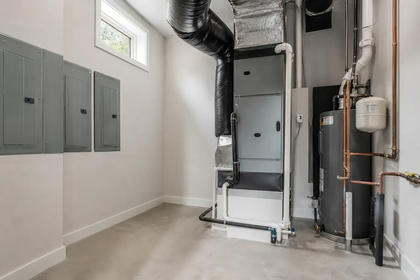 New Charlotte luxury custom-home mechanical room with coordinated residential equipment, ducts, piping, electrical panels, and clear service space