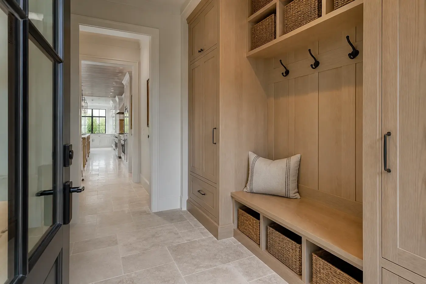 Everyday entry in a new Charlotte custom home leading through a white oak mudroom toward the kitchen