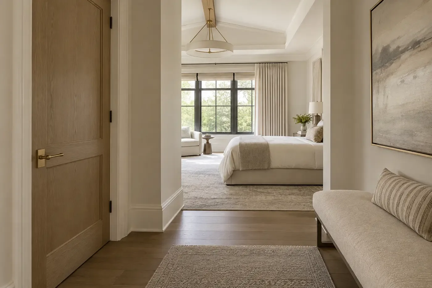 Illustrative luxury custom-home bedroom reached through a quiet private vestibule with a substantial wood door