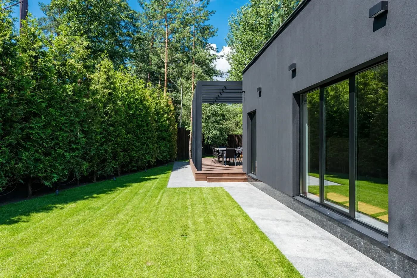 Representative custom-home side elevation with a clear landscaped access route