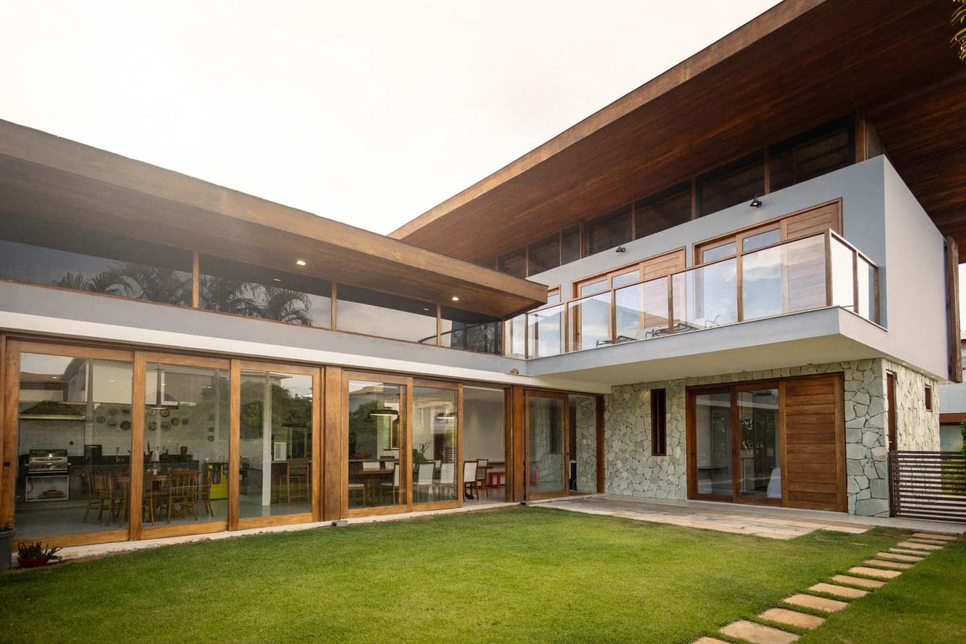 Representative luxury custom home with broad roof edges and landscaped grade for coordinated roof-drainage planning