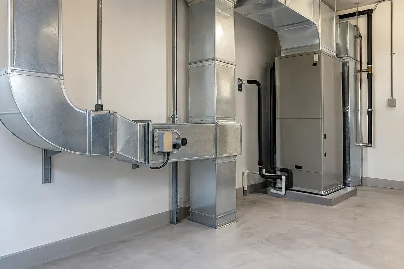 Illustrative residential mechanical room with organized ventilation ducts, damper assembly, and air-handling equipment