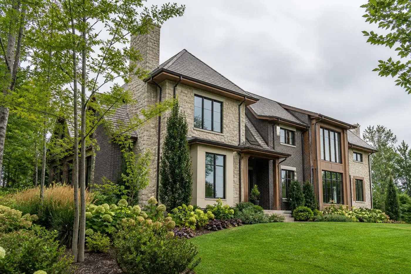 New Charlotte luxury custom home with coordinated rooflines, deep eaves, masonry walls, windows, gutters, and landscaped grade