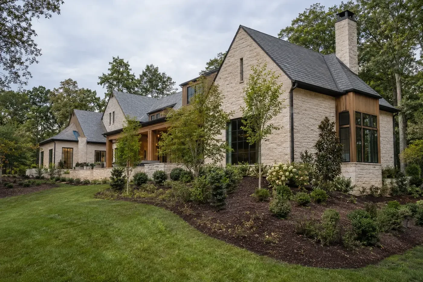 Illustrative Charlotte-area custom home with broad mulched planting beds, young trees, and preserved woodland